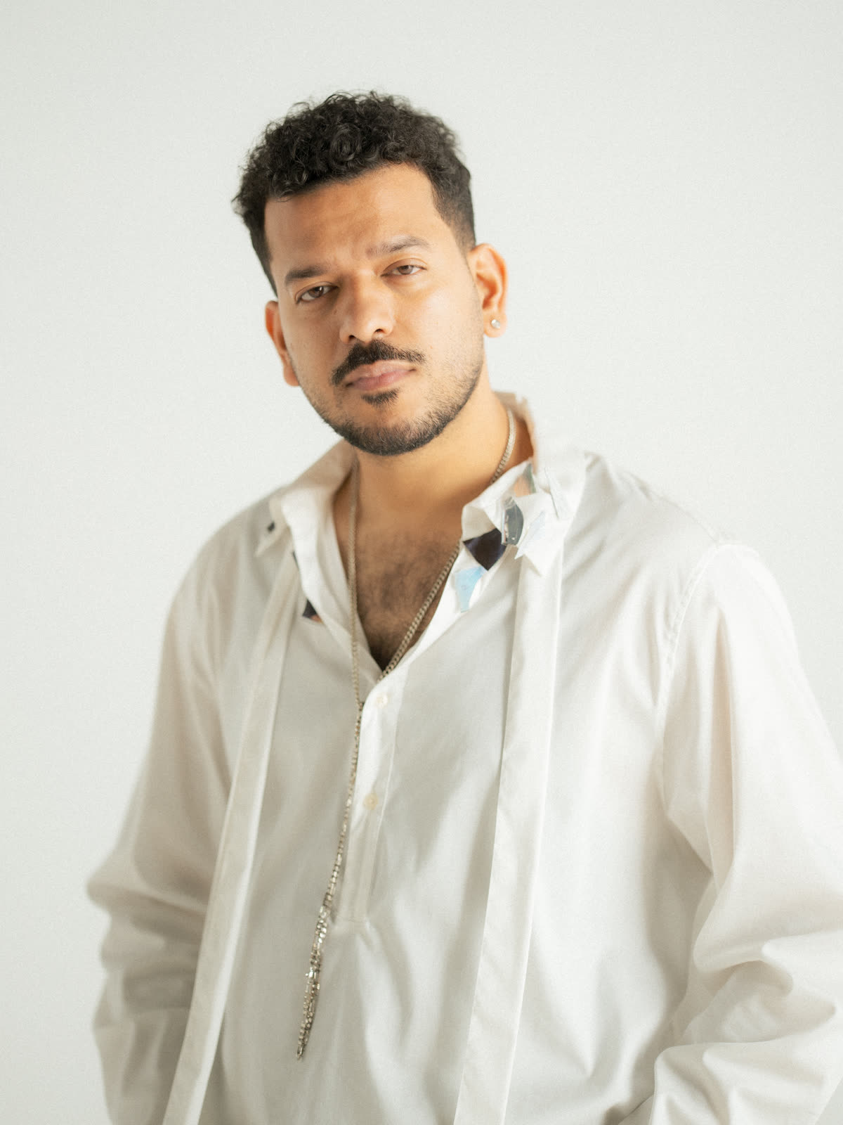 Semwal in a crisp white shirt, studio portrait